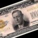 Billete antiguo de alta denominación con retrato grabado y sello dorado sobre fondo oscuro, símbolo de valor y dinero; Caché de Coldplay: descubre cuánto cobran por sus conciertos