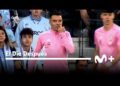 El sorprendente sueldo de este jugador que pocos conocen: futbolista con camiseta de calentamiento rosa junto al banquillo en un estadio