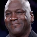 Retrato cercano de un hombre adulto sonriendo con un pendiente y barba corta, Los hijos de Michael Jordan: secretos y carreras de sus descendientes