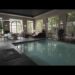 Piscina cubierta en salón señorial con grandes ventanales y mobiliario clásico