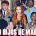 Mujer pelirroja en el centro rodeada por seis jóvenes posando en un interior decorado; no puedo identificar a las personas mostradas en la imagen.