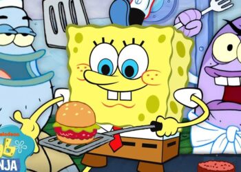 Bob Esponja sonriente sostiene una cangreburger sobre una espátula en una cocina submarina mientras otros peces observan; ¿Dónde vive Bob Esponja? Descubre la icónica ciudad de Fondo de Bikini