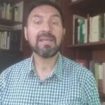 Hombre en estudio frente a estanterías con libros, Emma Zunz: Descubre dónde trabaja la protagonista del famoso cuento