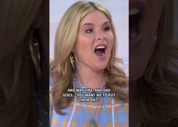Mujer rubia en un set televisivo con expresión sorprendida, boca abierta y subtítulos en inglés; no es posible identificar a la persona en la imagen.