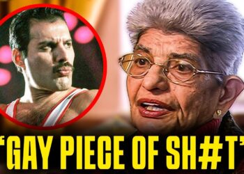 Primer plano de una mujer mayor hablando junto a un retrato circular de un cantante con bigote y un titular grande en inglés.