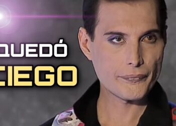 Primer plano de un cantante con maquillaje dramático y el texto 'QUEDÓ CIEGO' en estilo de miniatura promocional.