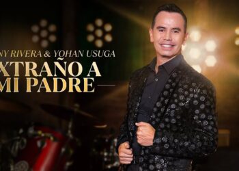 Cantante posando en un póster promocional con traje negro brillante y el texto 'Extraño a mi padre'.