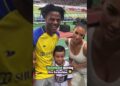 Mujer y varios niños posando sonrientes en un estadio con aficionados alrededor