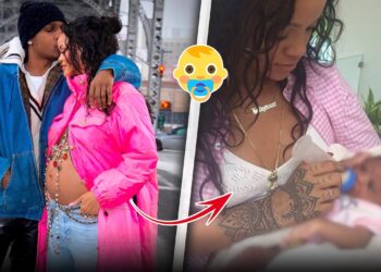 Mujer embarazada con abrigo rosa junto a su pareja en un puente, barriga decorada y beso en la frente lZiXjQ6ICHw