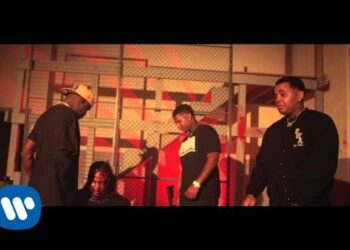 Grupo de cuatro hombres en un set urbano con iluminación roja y rejas; Descubre la familia de ukeleles: historia, tipos y artistas famosos