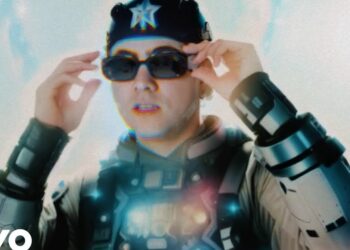 Persona con gafas oscuras y vestimenta futurista en un plano medio bajo intensa luz, Verdeliss y sus ocho hijos: descubre la vida de esta influencer