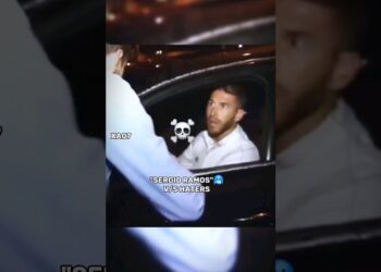 Futbolista sentado en el interior de un coche por la noche, imagen que sugiere controversia y referencias al sueldo en el Sevilla FC.