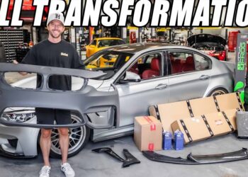 Hombre en taller sostiene un parachoques frente a un coche deportivo gris con interior rojo y piezas apiladas; T.J. Holmes revela sorpresas impactantes sobre su futuro junto a Amy Robach que no querrás perderte.