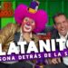 Payaso con peluca fucsia, maquillaje característico y sombrero diminuto junto a un entrevistador sonriente en un set colorido, ¿Qué fue de Platanito? La sorprendente transformación del comediante.