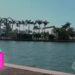 Descubre la lujosa casa de Shakira en Miami: detalles y secretos, mansión frente al mar con palmeras, muelle y fachada elegante bajo cielo azul.