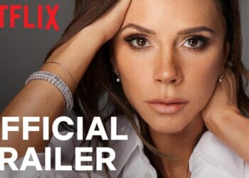 Descubre quiénes fueron los famosos mejor vestidos en un espectacular desfile en París ¡No te lo puedes perder! Primer plano de una mujer elegante con pulseras brillantes, maquillaje sutil y el logo de Netflix junto al texto 'Official Trailer'.