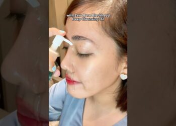 Mujer aplicando aceite limpiador facial con una gota visible desde el dispensador mientras cierra los ojos; Descubre el secreto de belleza de Kyle Richards y Alix Earle: ¡toner pads para poros a más del 50% de descuento!